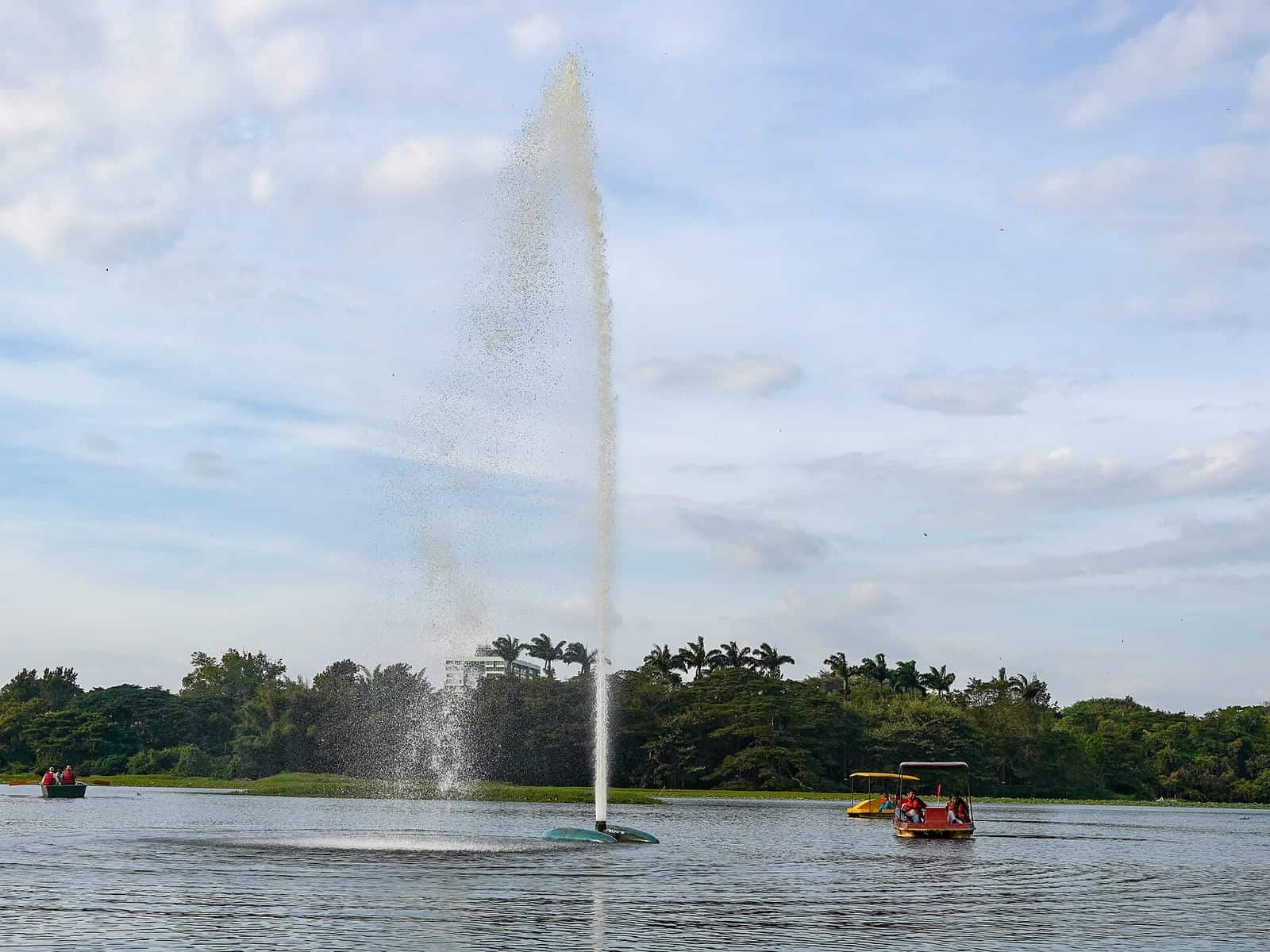 A fountain and pedal boats on Karanji Lake in Mysuru