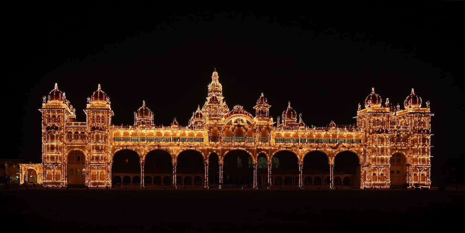 Mysore Palace lit up at night with thousands of bulbs