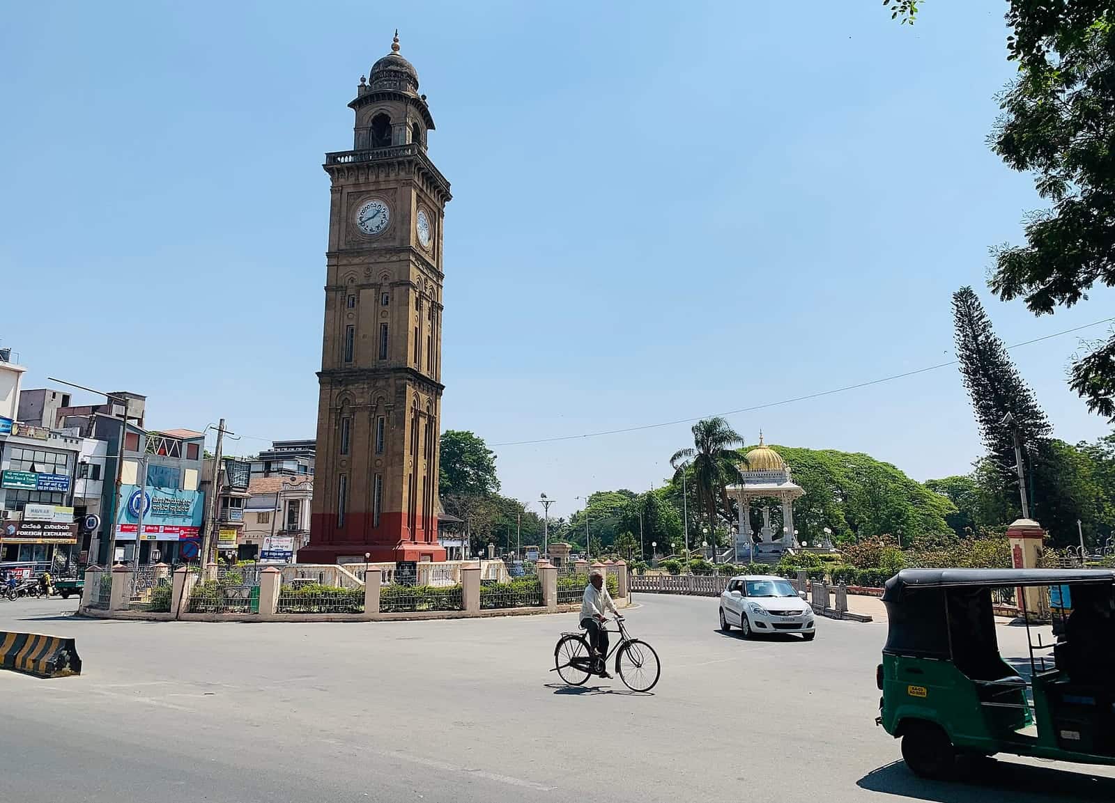 A clock tower at a traffic circle in central Mysuru