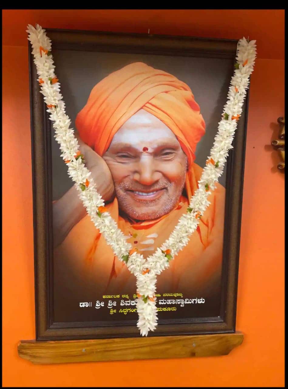 Framed portrait of Dr. Sri Sri Shivakumara Mahaswamigalu of Siddaganga Mutt at the office