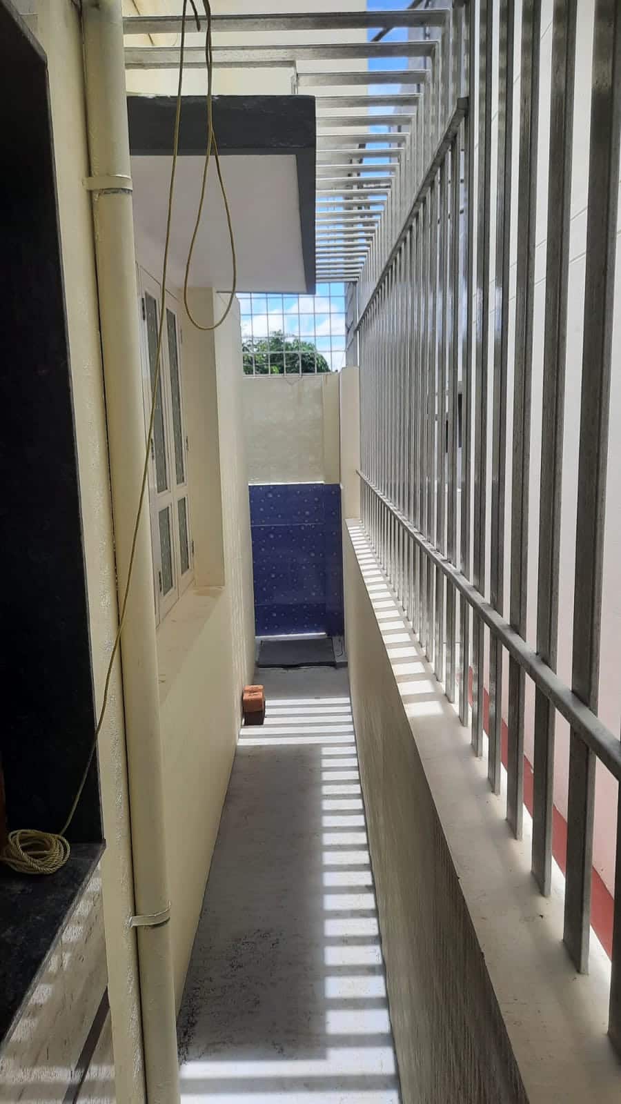 A tiled staircase with a metal railing inside a new house
