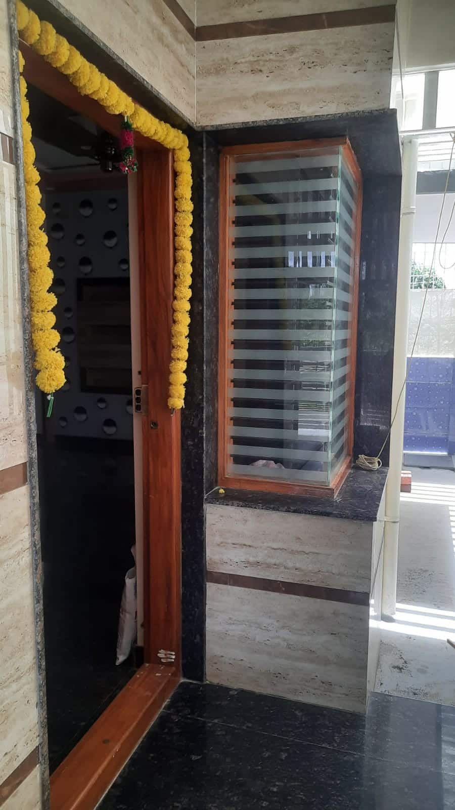 A home's entrance decorated with strings of marigolds