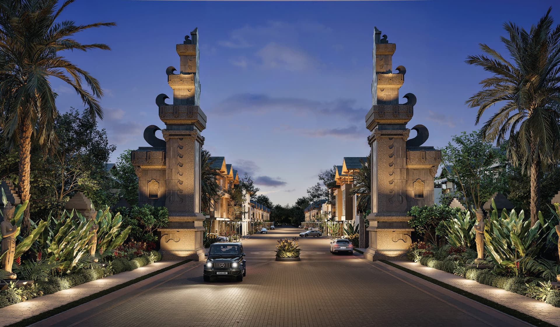 The Balinese stone entrance gate of Ayana Woods at dusk