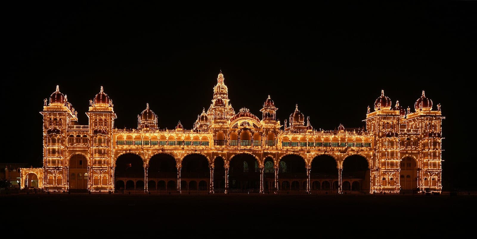 Mysore Palace lit up at night with thousands of bulbs