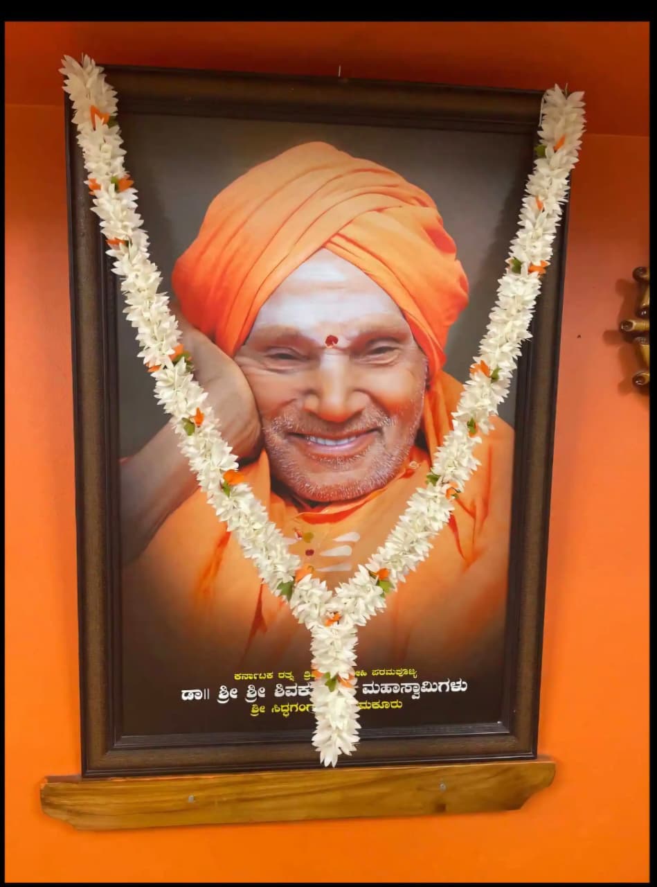 Framed portrait of Dr. Sri Sri Shivakumara Mahaswamigalu of Siddaganga Mutt at the office