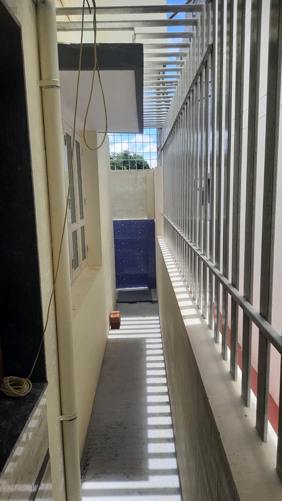 A tiled staircase with a metal railing inside a new house