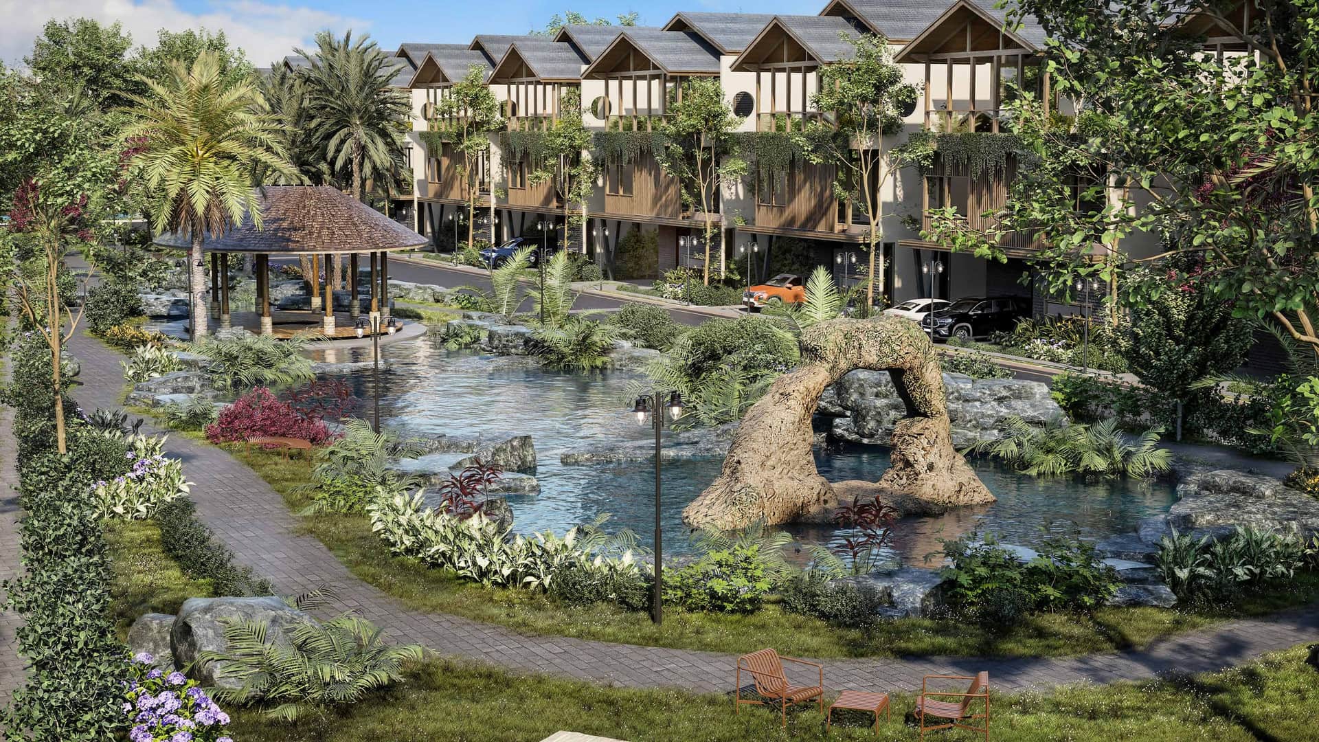 Landscaped park with natural stone, water and a thatched pavilion at Ayana Woods