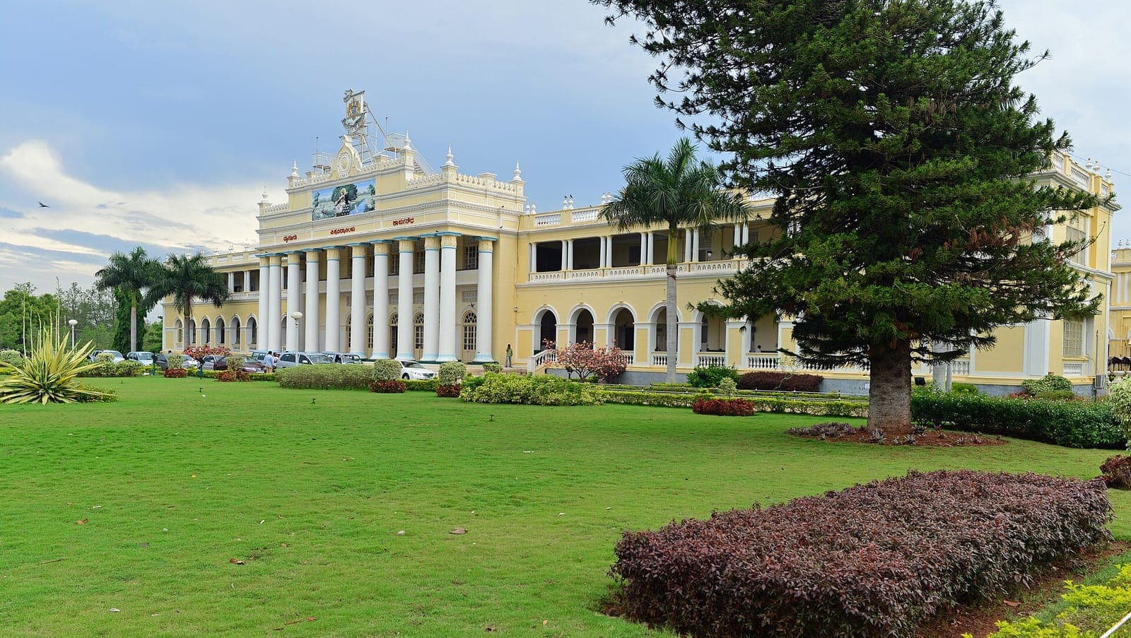 Crawford Hall, University of Mysore, behind a lawn and pine trees