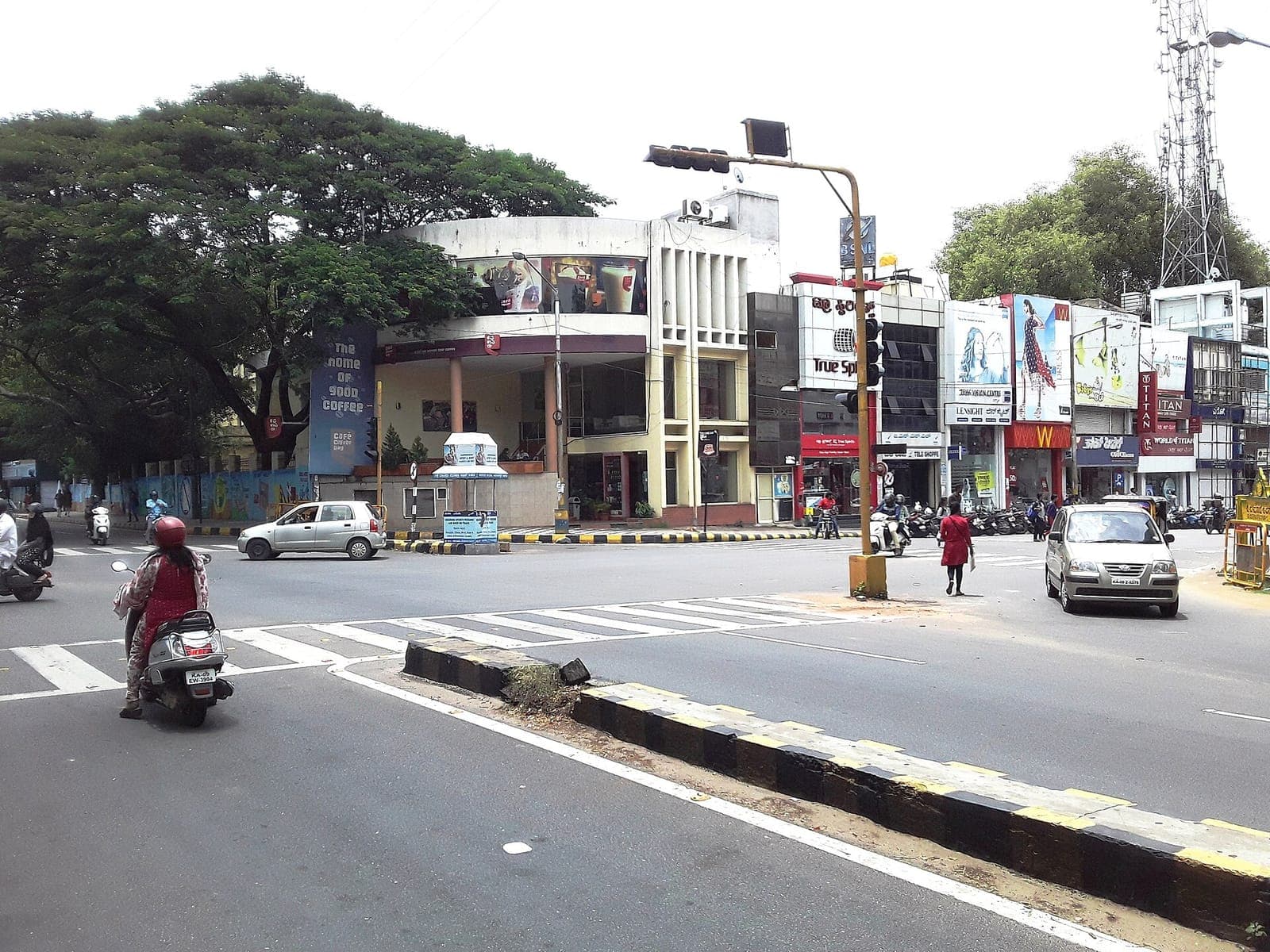 Shops and traffic on Devaraj Urs Road in Mysuru