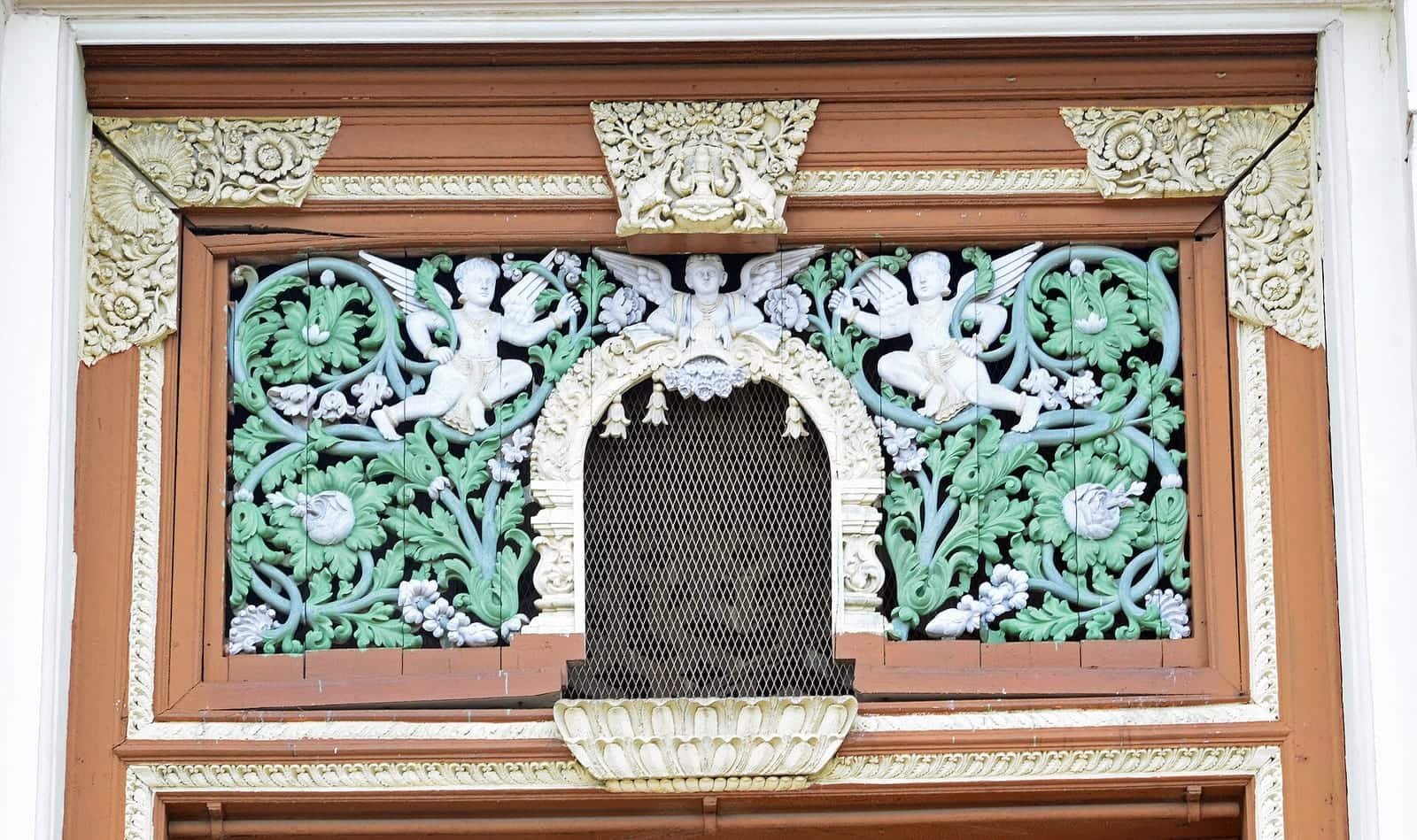 Carved and painted ornament above a window at Jaganmohan Palace