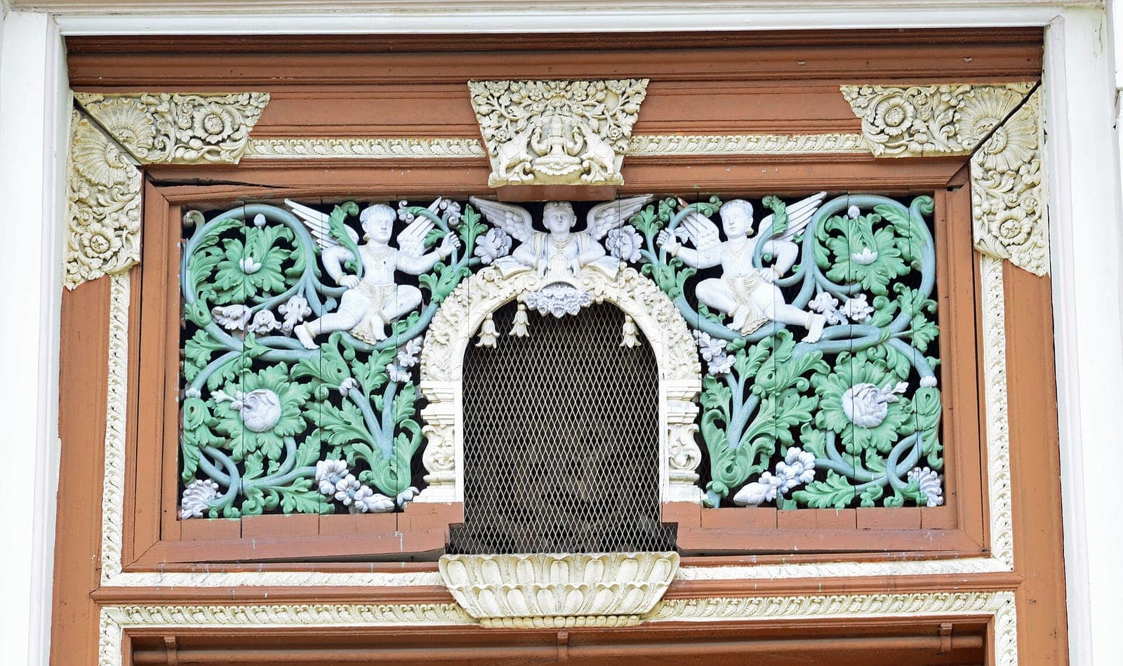 Carved and painted ornament above a window at Jaganmohan Palace