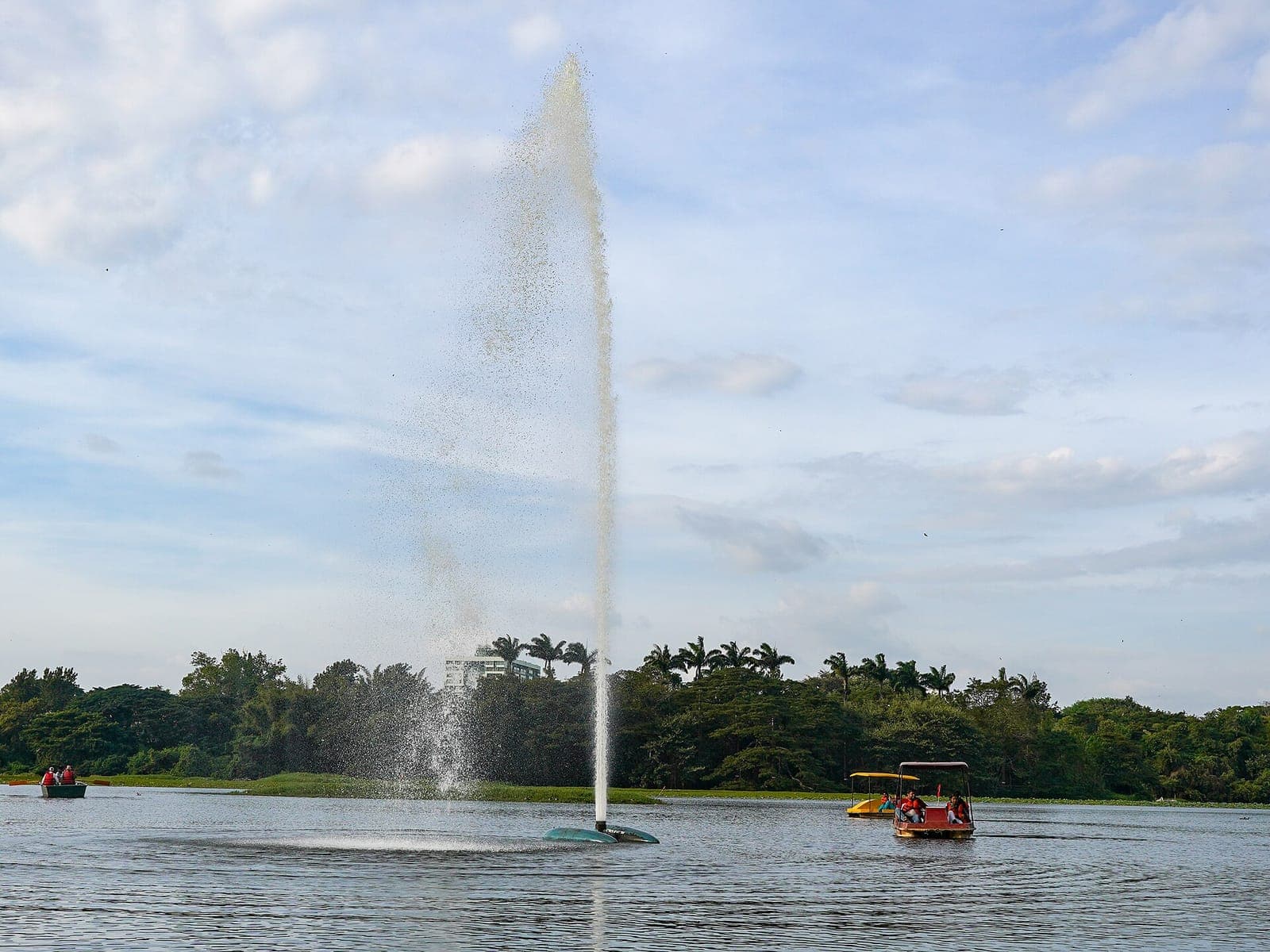 A fountain and pedal boats on Karanji Lake in Mysuru