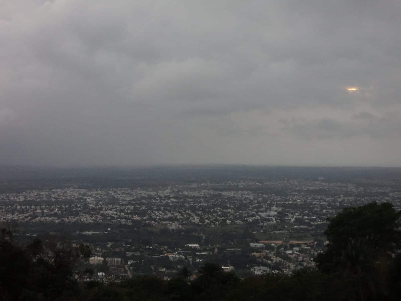 A hazy view over Mysuru's rooftops from Chamundi Hills