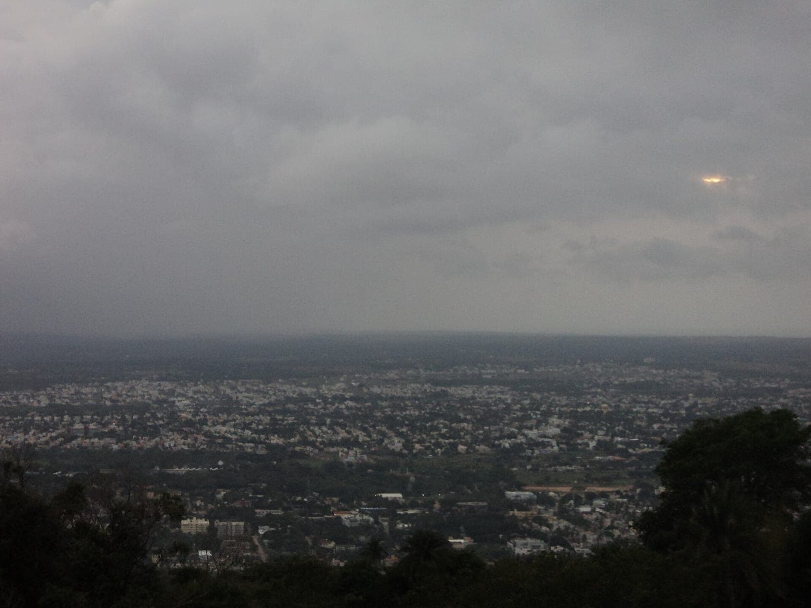 A hazy view over Mysuru's rooftops from Chamundi Hills