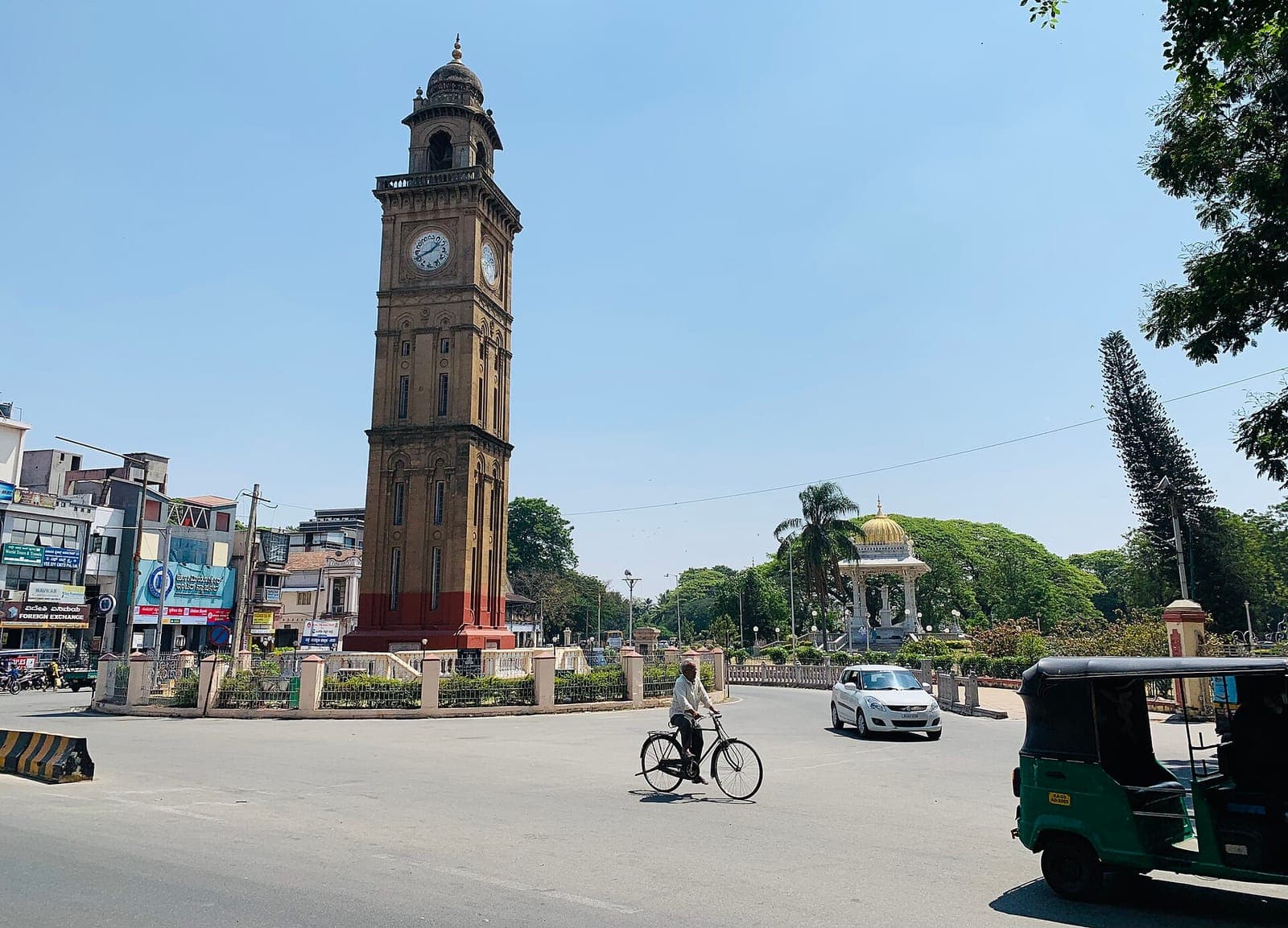 A clock tower at a traffic circle in central Mysuru