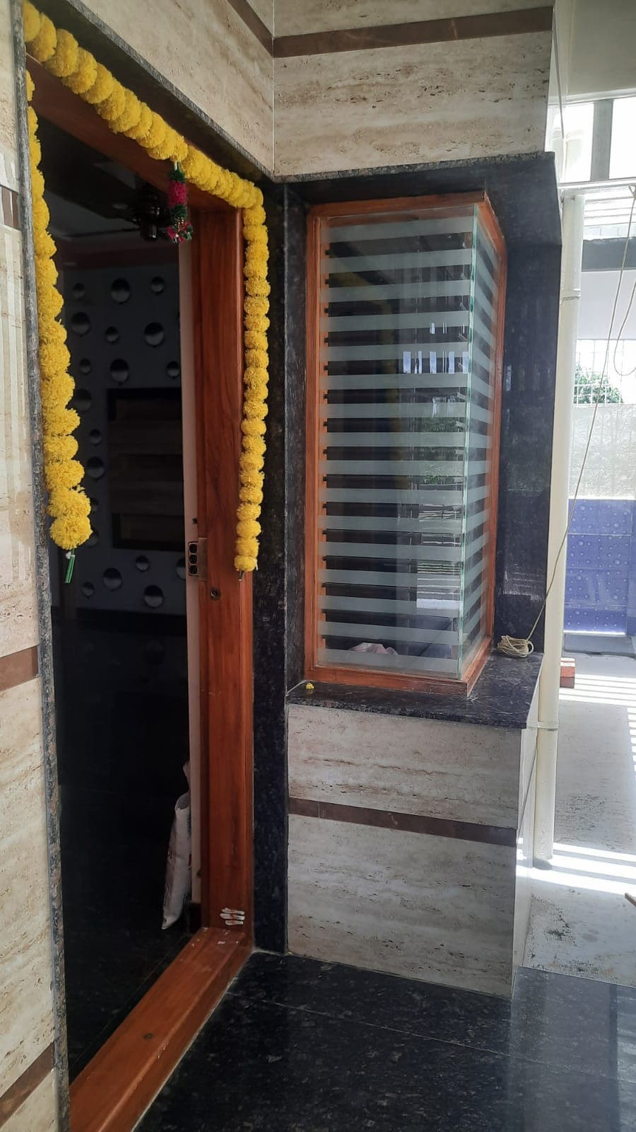 A home's entrance decorated with strings of marigolds
